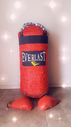 a red boxing bag sitting on top of a tiled floor