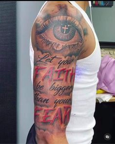 a man with an eye tattoo on his arm