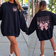 Dance your heart out in style with our "Dance" Sweatshirt featuring a Coquette Bow! 💃🎀 This fashionable and comfortable sweatshirt is perfect for every dancer who loves to add a touch of elegance to their dancewear. Featuring the word "Dance" paired with a cute coquette bow, this sweatshirt is the ideal way to celebrate your passion for dance with flair. 🎨 Vibrant and Trendy Colors: Available in a variety of fashionable colors, this sweatshirt is designed to match your style. Choose your favo Dance Student Gifts, Stretch Black Top For Dance Class, Black Stretch Top For Dance Class, Black Dancewear Tops For Dance, Hip Hop Stretch Sweatshirt For Fall, Hip Hop Style Stretch Sweatshirt For Fall, Fall Stretch Hip Hop Sweatshirt, Hip Hop Crew Neck Top For Dance, Hip Hop Style Crew Neck Top For Dance