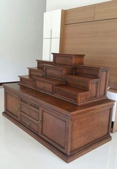 a large wooden dresser sitting on top of a white floor