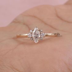 a woman's hand with a diamond ring on it