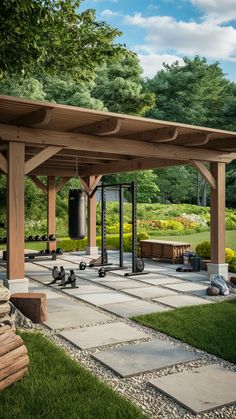 an outdoor gym is shown with benches and other equipment in the foreground, surrounded by lush green trees