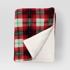 a red and green plaid blanket folded up