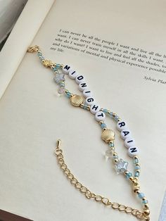 an open book with a chain bracelet on it