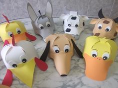 a group of paper animal masks sitting on top of a marble counter covered in frosting