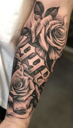 a black and white rose tattoo on the arm