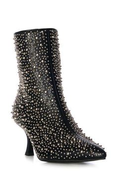 Polished studs create an edgy aesthetic on a bold bootie balanced by a pointy toe and tapered flare heel. Side zip closure Synthetic upper, lining and sole Imported Asian & Pacific Islander Owned/Founded Punk Heeled Boots For Night Out, Fall High Heels With Silver Studs, High Heel Boots With Silver Studs For Fall, High Ankle Boots With Spikes For Fall, Edgy Spiked Heeled Boots With Round Toe, Punk Stud Heeled Boots For Fall, Punk Studs Heeled Boots For Fall, Punk Style High Ankle Heeled Boots For Party, Fall High Ankle Boots With Spikes