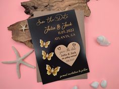 a wedding save the date card with butterflies and seashells on it next to starfish