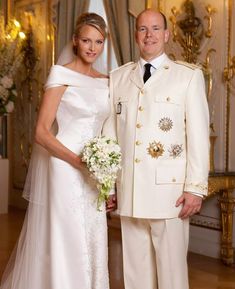 a man and woman in formal wear posing for a photo on their wedding day at the palace