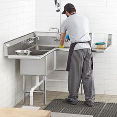 a man is washing his hands in the sink