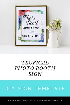 the tropical photo booth sign is displayed next to a vase with flowers