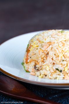 a white plate topped with rice and vegetables