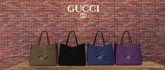 gucci handbags on display in front of a brick wall with the word gucci