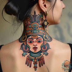 the back of a woman's neck with an elaborate tattoo design on her neck