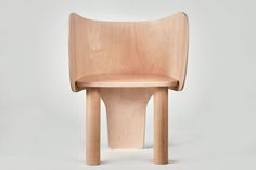 a wooden chair sitting on top of a white floor