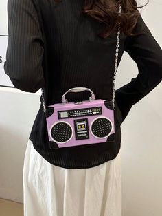 Introducing the Radiant Melody: Purple Radio Handbag, a trendy music-inspired crossbody bag. With its stylish design and convenient crossbody strap, this bag is perfect for carrying all your essentials while adding a touch of music to your outfit. Made from high-quality materials, it is both durable and fashionable. Elevate your fashion game with this must-have accessory. Color : Purple Details : Chain, Spiked Type : Novelty Bag, Square Bag, Box Bag, Camera Bag Bag Size : Mini Closure Type : Buc Trendy Shoulder Bag For Concerts, Trendy Rectangular Shoulder Bag For Concert, Trendy Rectangular Shoulder Bag For Concerts, Trendy Rectangular Bag For Concerts, Crossbody Bag With Adjustable Strap For Concerts, Trendy Music, Purple Details, Trendy Handbags, Novelty Bags