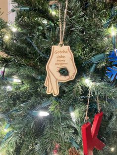 an ornament hanging from the top of a christmas tree that says grandpa's helpers merry