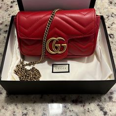 “Like New”Gg Marmont Leather Super Mini Bag Still Smells “ Brand New” Hibiscus Red Matelass Chevron Leather With Hibiscus Red Leather Detail Gold-Toned Hardware Attached Key Ring That Can Attach To A Separate Bag Double G Chain Shoulder Strap With 23.6" Drop This Item Can Fit A Cell Phone Up To 2.7”W X 5.8”H X .3”D The Gucci Card Case Wallet Will Fit Inside This Product Weight: .35kg Approximately Super Mini Size: 6.2"W X 4"H X 1.7"D Made In Italy Retail $1200 Asking $985 Comes W/ Original Box A Lights Winter, Hibiscus Red, Landscape Forest, Best Designer Bags, Buy List, Ladies Bag, Latest Bags, Replica Designer Handbags, Chanel Purse