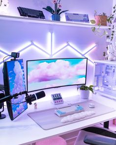 a desk with a computer monitor, keyboard and mouse on it next to a plant