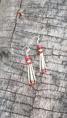 These earrings are handmade with natural porcupine quills.  They are strung on lightweight nymo thread, with red and beige tiny glass seed beads.   Each pair of these porcupine quill earrings are uniquely, and naturally elegant.  At the top of each of these porcupine quill earrings are red and light brown natural wood beads.   The porcupine quills in these earrings are each individually handwashed and trimmed to remove the sharp ends. These porcupine quill earrings measure (drop length - from th Porcupine Quill Jewelry, Quill Jewelry, Native American Jewellery, Porcupine Quills, Small Boutiques, Native American Beadwork, Native American Style, Southwest Art, Red Beads