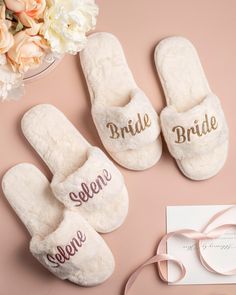 the bride and groom slippers are on display next to a card, flower bouquet, and sunglasses