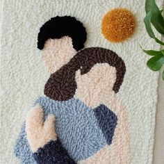 a crocheted rug with an image of a woman and a flower on it