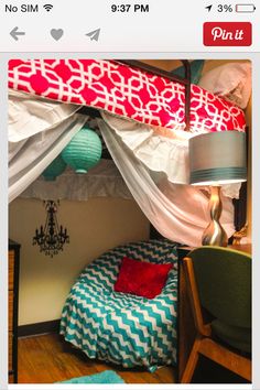 a room with a bed, desk and chair in it that is decorated like a tent