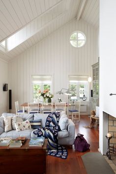 a living room filled with furniture and a fire place in the middle of a room