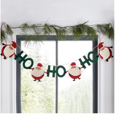 christmas decorations with santa claus and snowmen hanging from the window