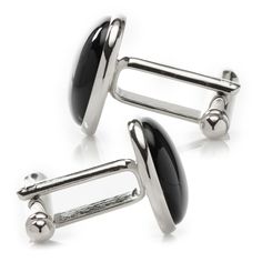 Classic and chic, our Silver and Onyx Cufflinks grant an immediate ensemble boost to your formal wardrobe. Smooth, deep Onyx discs nestle inside silver-finished settings for a simple, classic look suitable for any event. The expert craftsmanship of our base metal cufflinks ensures long-lasting durability. Pairs perfectly with our Onyx Inlaid Tie Clip. Sleek Black Jewelry For Formal Occasions, Elegant Formal Clip-on Cufflinks, Sleek White Gold Jewelry For Formal Occasions, Classic Formal Jewelry With Shiny Finish, Modern Black Cufflinks For Business, White Gold Cufflinks With Polished Finish For Formal Occasions, Modern White Gold Cufflinks With Polished Finish, Modern Polished Jewelry For Business, Modern Polished Finish Jewelry For Business