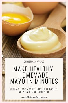 a wooden spoon filled with mayonnaise next to eggs on top of a table