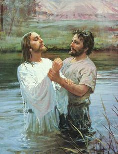 two men standing in the water with their arms around each other and holding hands together