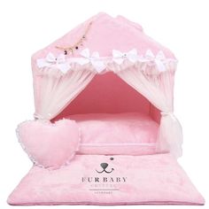 a pink dog bed with white bows on it's head and the name furbaby