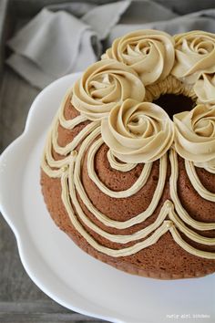 a chocolate cake with frosting on a white plate