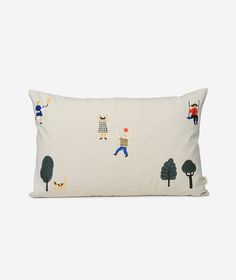 a white pillow with people and trees on it