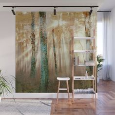 an angel painting on a wall with a ladder in the foreground and a potted plant next to it