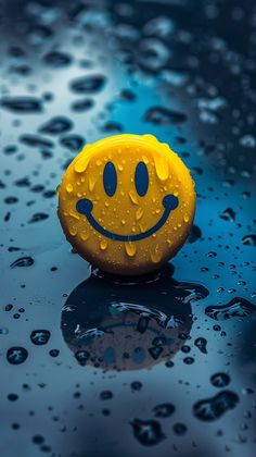 a yellow smiley face sitting on top of a wet surface