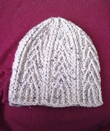 a white knitted hat on top of a purple sweater