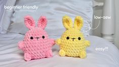 two crocheted stuffed animals sitting on top of a bed next to each other