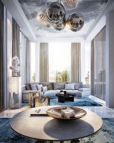 a living room with couches, tables and chandeliers