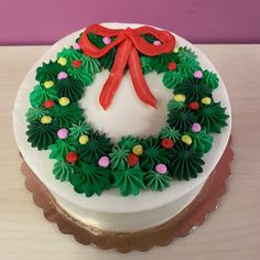 a white cake with green and red decorations