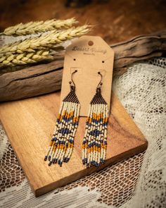 the earrings are made with seed beads and beaded in blue, yellow and white