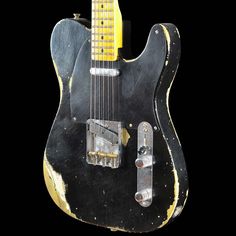 an old black and yellow electric guitar