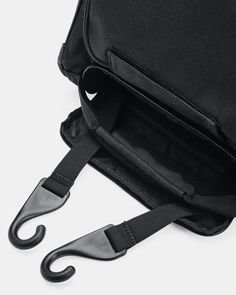 a black bag with an umbrella handle hanging from it's back pocket, on a white background