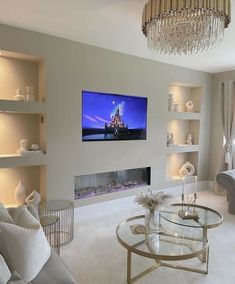 a living room filled with furniture and a flat screen tv mounted on the wall above a fireplace