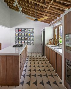 a kitchen with tiled flooring and wooden ceiling