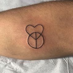 a person's arm with a heart and two intertwined circles tattoo on it