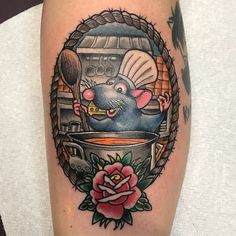 a rat in a pot with spoon and rose tattoo on the leg, done by person