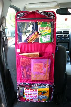 the back seat of a car is filled with books and other things to pack in