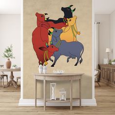 three bulls are standing on top of each other in front of a beige wall with a wooden table